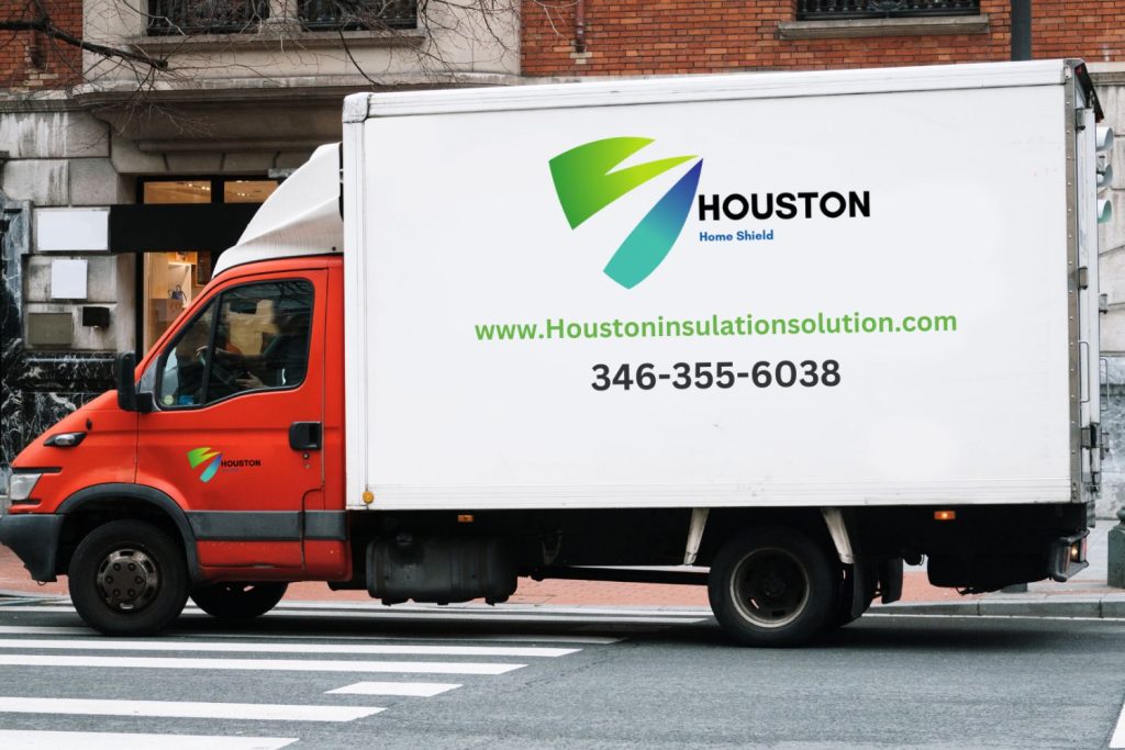 A white and red delivery truck with "HOUSTON" branding and contact information, parked on a city street.